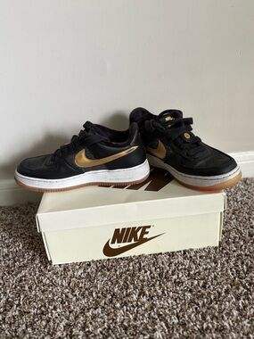 Nike Black Sneakers with Metallic Gold Swoosh
